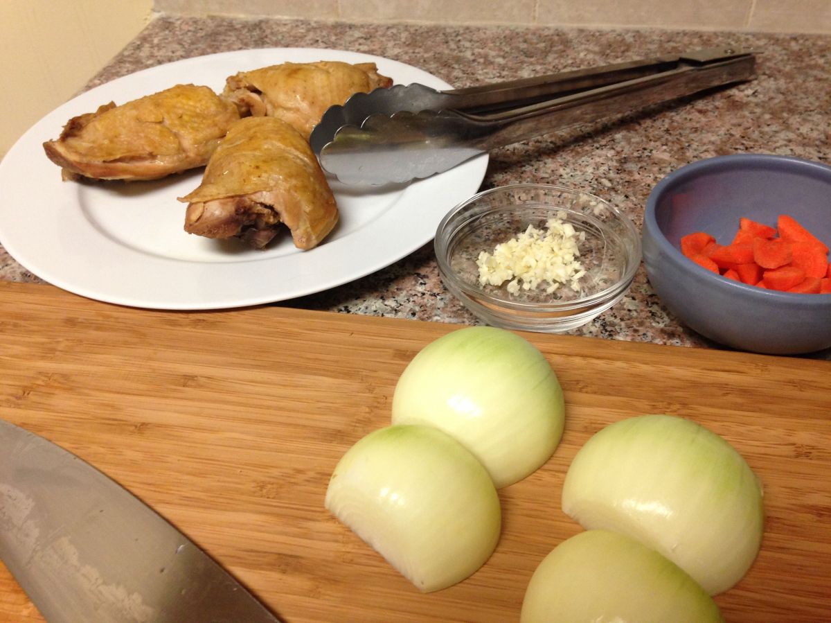 Poached chicken thighs, onions, garlic, and carrots.