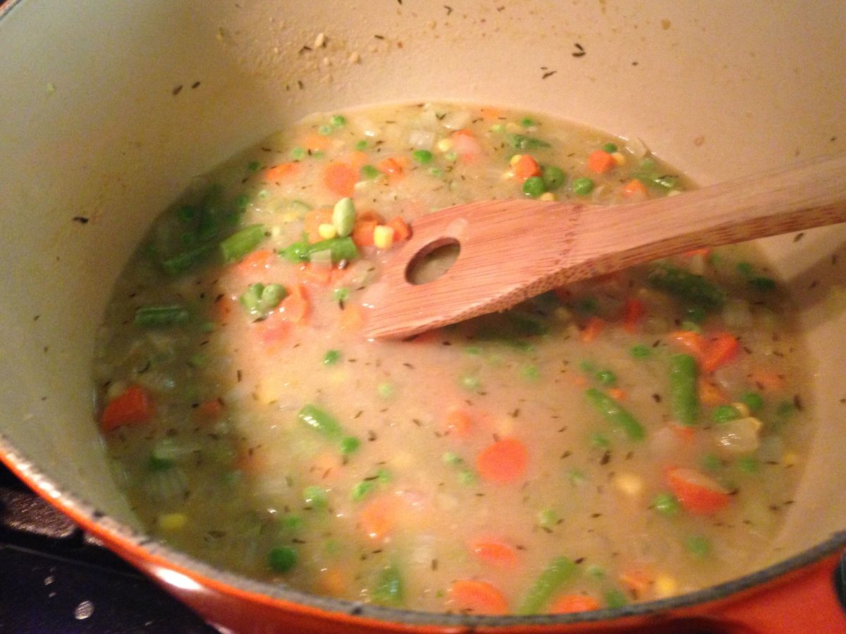 Add the stock. And frozen veggies.